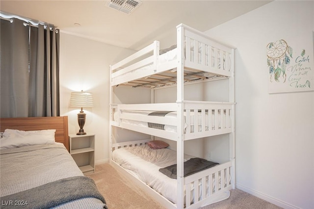 bedroom featuring light carpet