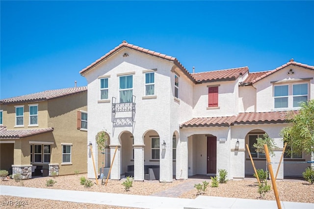 mediterranean / spanish-style house featuring a balcony