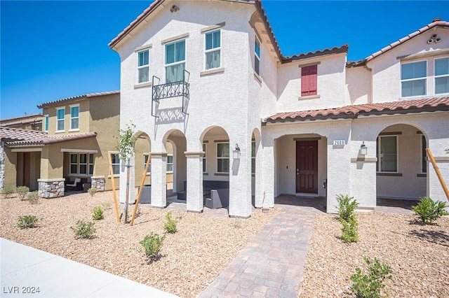 mediterranean / spanish-style home featuring a patio area