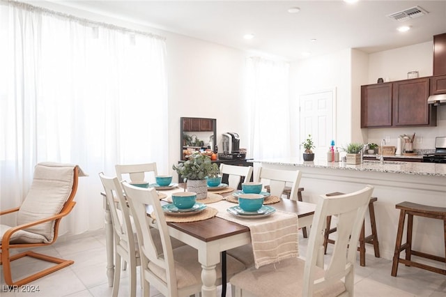 tiled dining room with sink