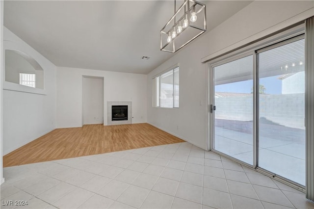 unfurnished living room featuring a fireplace and light hardwood / wood-style flooring