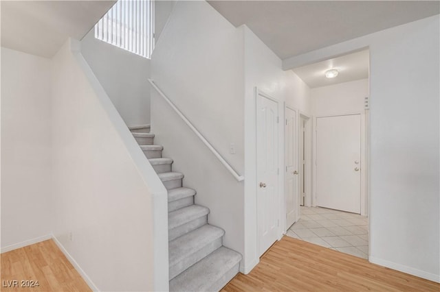 stairway featuring wood-type flooring