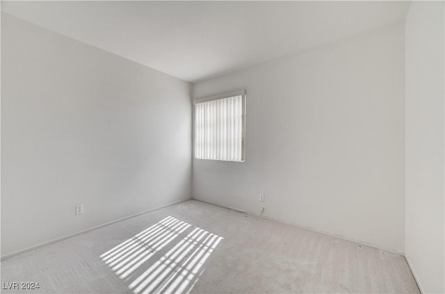 empty room featuring light colored carpet