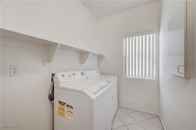 laundry room with separate washer and dryer and light tile patterned flooring