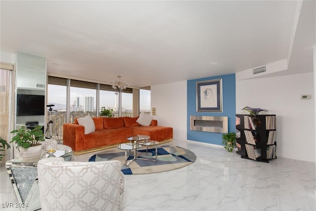 living room featuring a chandelier and a wall of windows