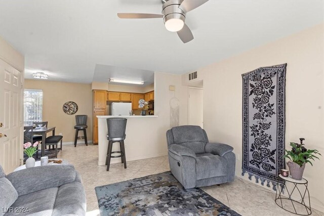 tiled living room with ceiling fan