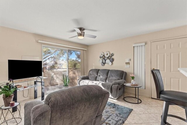 living room with light tile patterned floors and ceiling fan