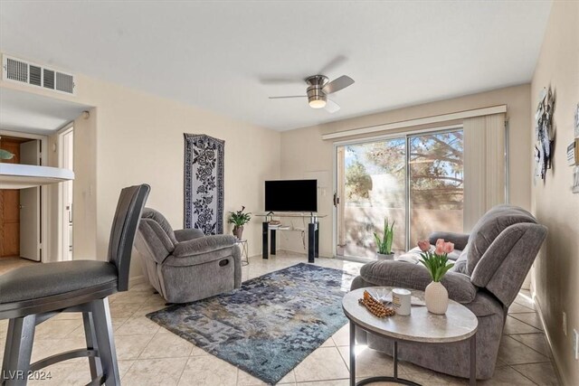 tiled living room featuring ceiling fan