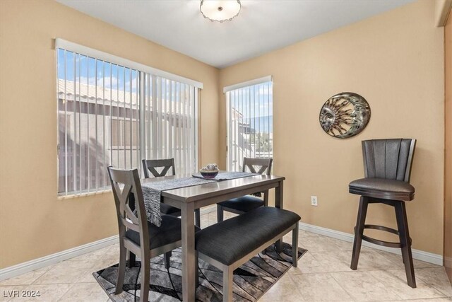 dining space featuring light tile patterned flooring