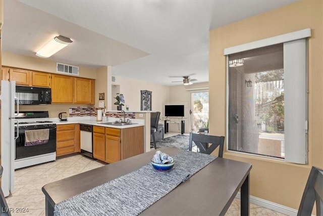 kitchen with sink, stainless steel dishwasher, ceiling fan, gas range gas stove, and kitchen peninsula