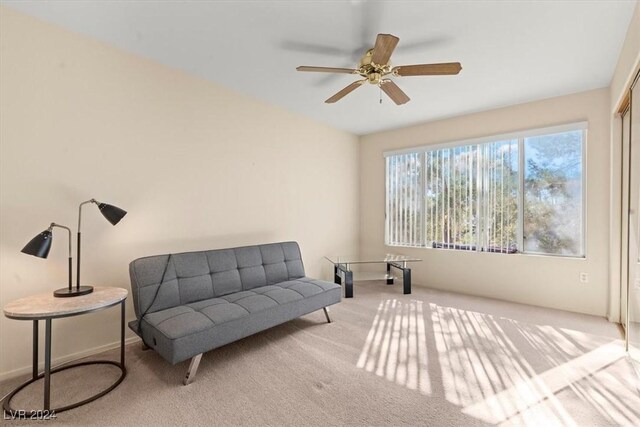 sitting room featuring ceiling fan and light carpet