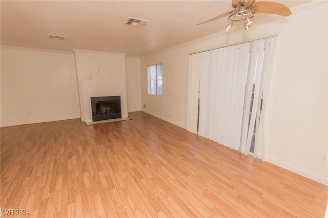 unfurnished living room featuring light hardwood / wood-style floors, ceiling fan, and ornamental molding