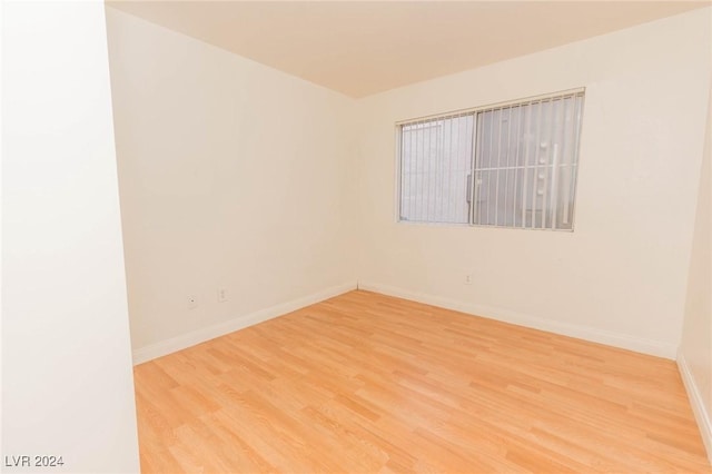 unfurnished room with wood-type flooring