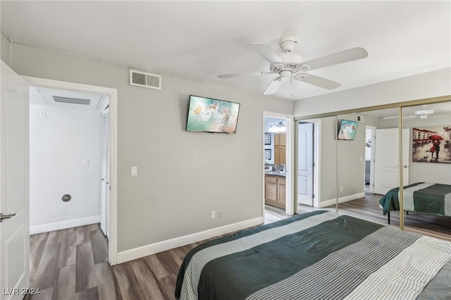 bedroom featuring hardwood / wood-style floors, a closet, ceiling fan, and ensuite bathroom