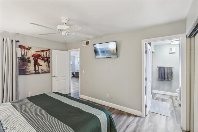 bedroom featuring ceiling fan, connected bathroom, and light hardwood / wood-style flooring