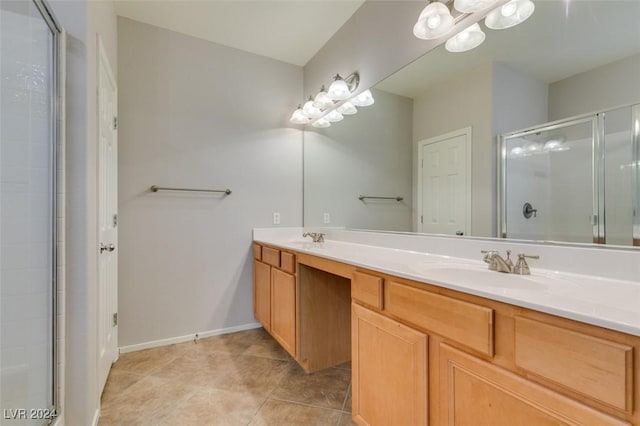 bathroom featuring tile patterned floors, vanity, and an enclosed shower