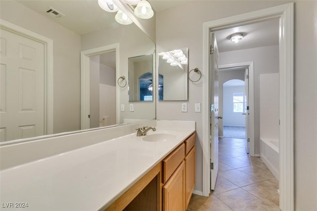 bathroom featuring tile patterned flooring, vanity, and a bathtub