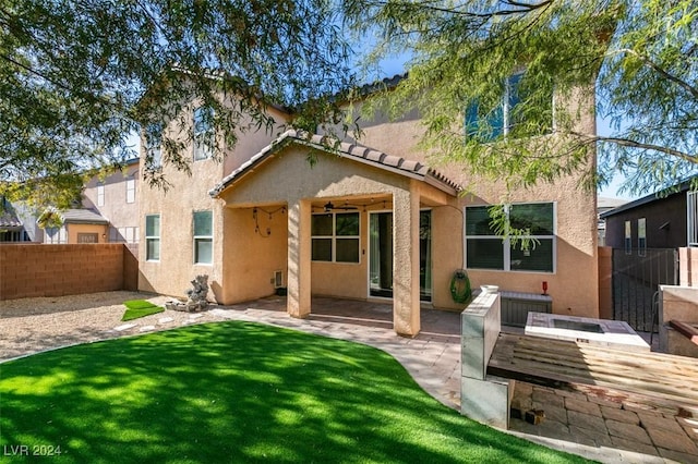 back of house with a patio area and a yard