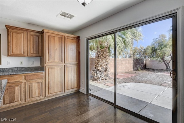 doorway to outside with dark wood-type flooring