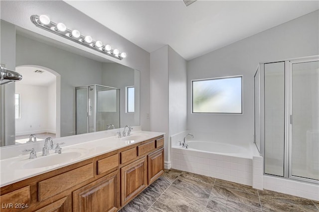 bathroom featuring lofted ceiling, plus walk in shower, and vanity