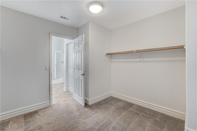 walk in closet with carpet floors