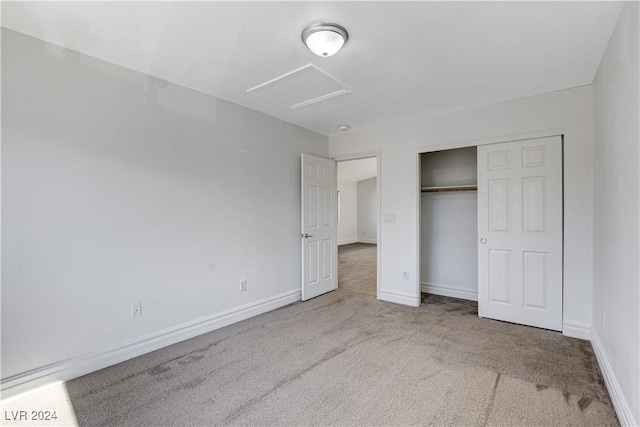 unfurnished bedroom with a closet and carpet