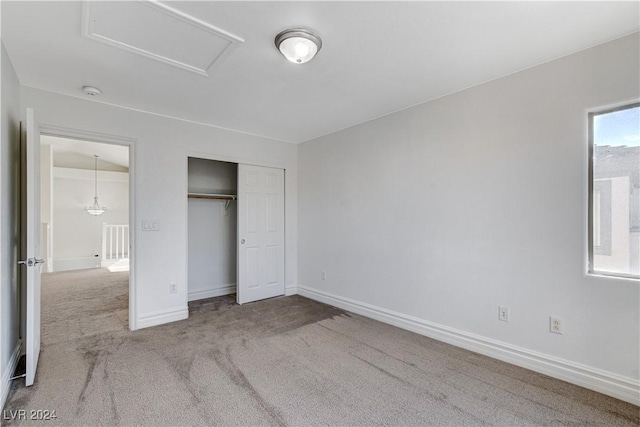 unfurnished bedroom with a closet and carpet