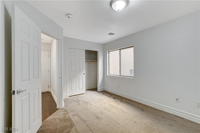 unfurnished bedroom featuring carpet floors and a closet