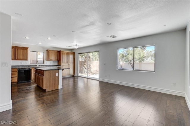 kitchen featuring dark hardwood / wood-style flooring, dishwasher, sink, and a kitchen island