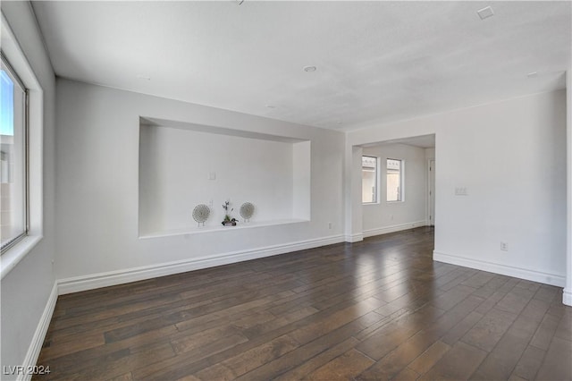 spare room featuring dark wood-type flooring