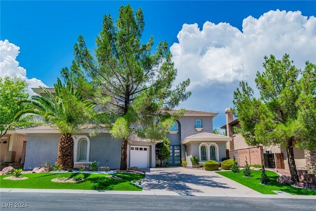 mediterranean / spanish home with a garage