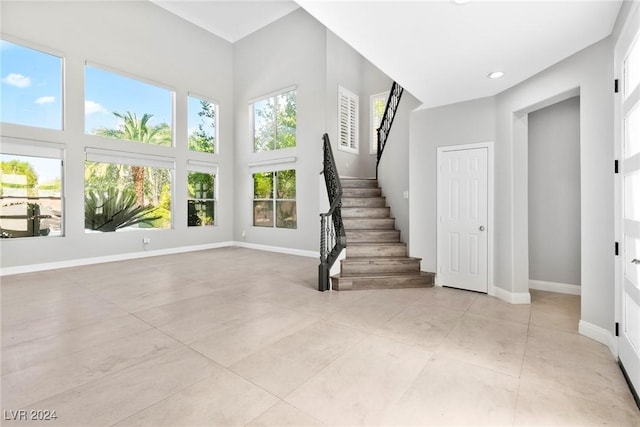 interior space with tile patterned flooring and a high ceiling