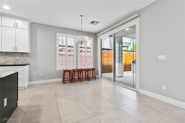 unfurnished dining area with a healthy amount of sunlight and light tile patterned flooring