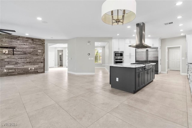 kitchen with pendant lighting, a center island, white cabinets, island exhaust hood, and stainless steel appliances