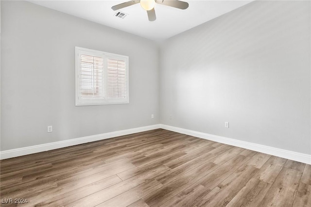 empty room with ceiling fan and wood-type flooring