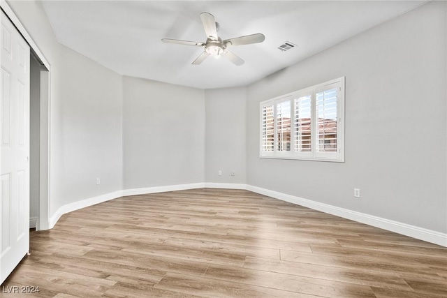 unfurnished bedroom with light wood-type flooring, a closet, and ceiling fan