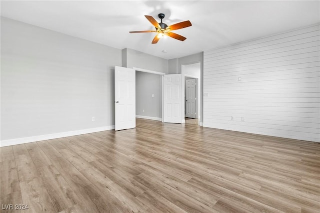 unfurnished bedroom with ceiling fan and light hardwood / wood-style floors