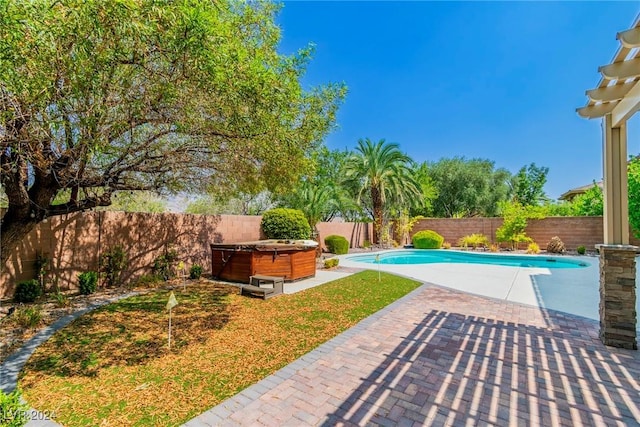 view of pool with a patio and a hot tub