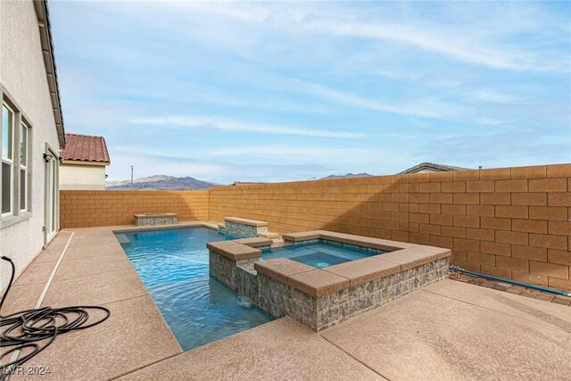 view of swimming pool with an in ground hot tub and pool water feature