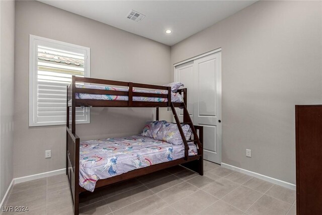 tiled bedroom featuring a closet