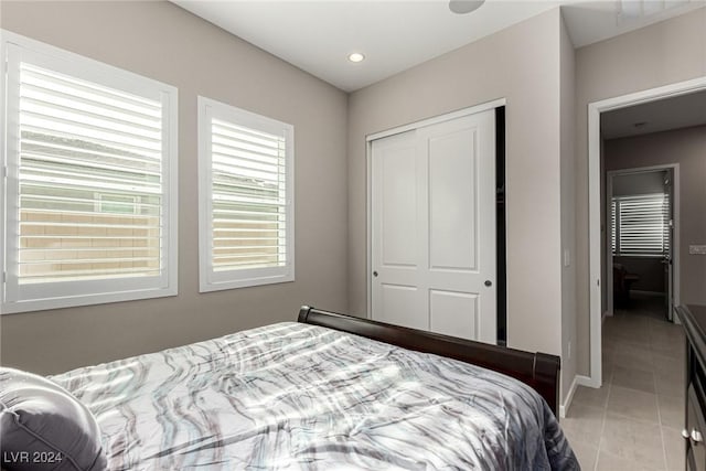 bedroom featuring a closet and light tile patterned floors