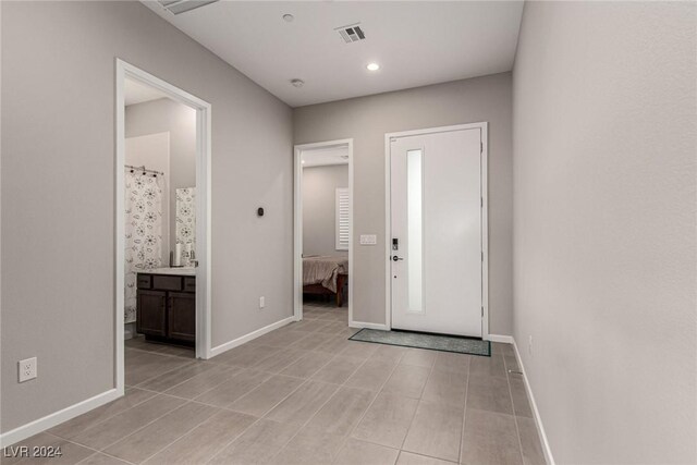 foyer featuring light tile patterned flooring