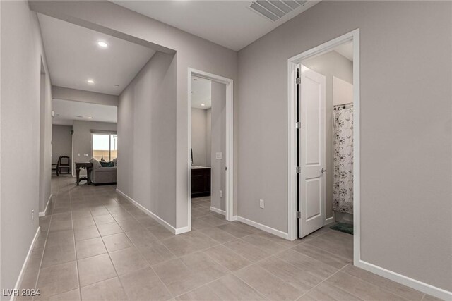 hall with light tile patterned floors