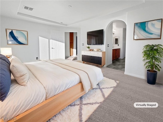 carpeted bedroom featuring ensuite bathroom