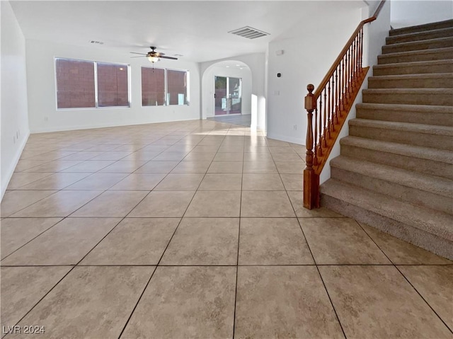 tiled foyer with ceiling fan