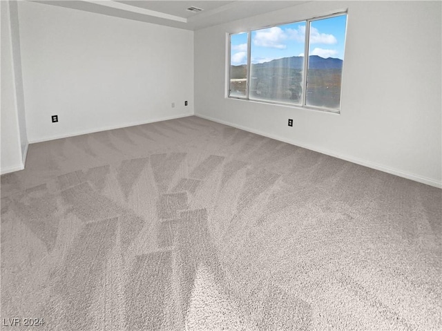 carpeted empty room with a mountain view