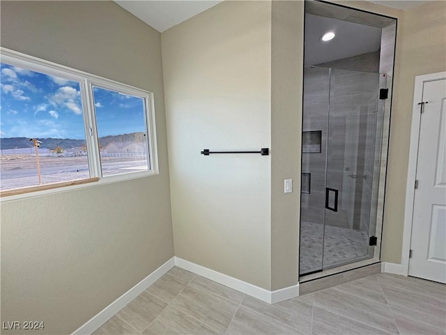 bathroom featuring tile patterned flooring and an enclosed shower