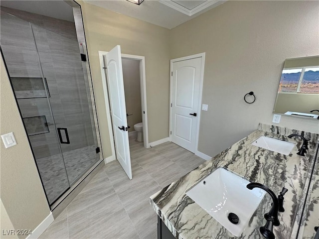 bathroom with tile patterned floors, vanity, toilet, and a shower with shower door