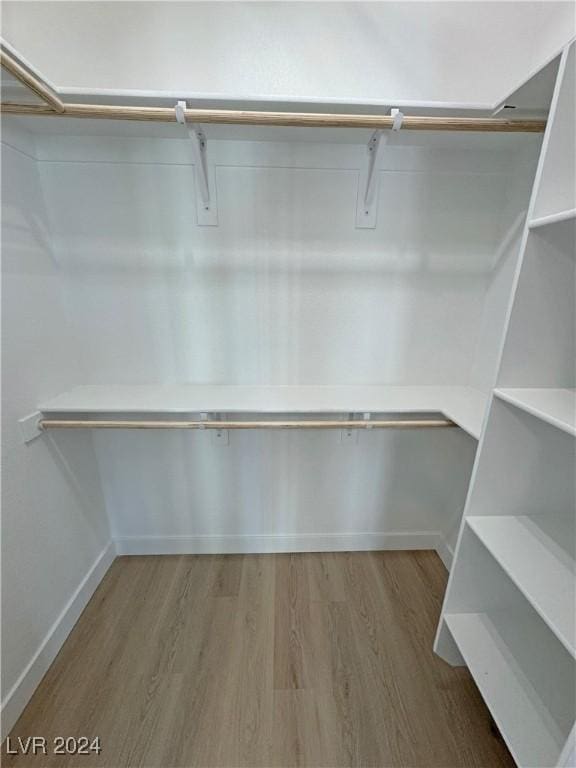 spacious closet featuring hardwood / wood-style floors