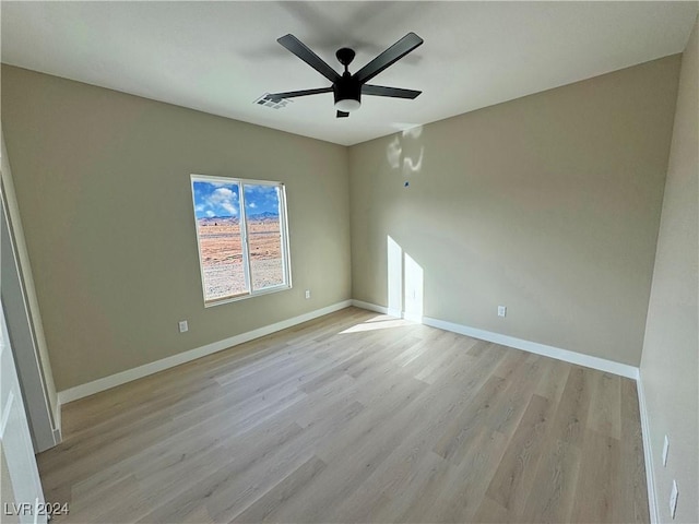 empty room featuring ceiling fan and light hardwood / wood-style floors